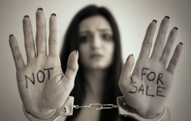 Sex trafficking: Woman in handcuffs with hands showing, "Not For Sale"