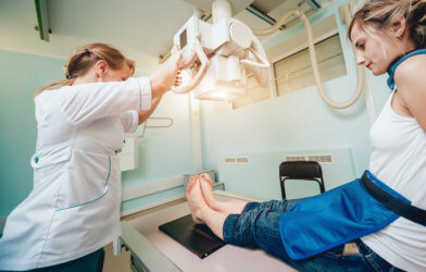 Woman having X-ray on legs