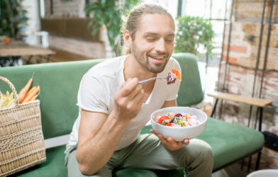 Man eating salad, enjoying healthy diet