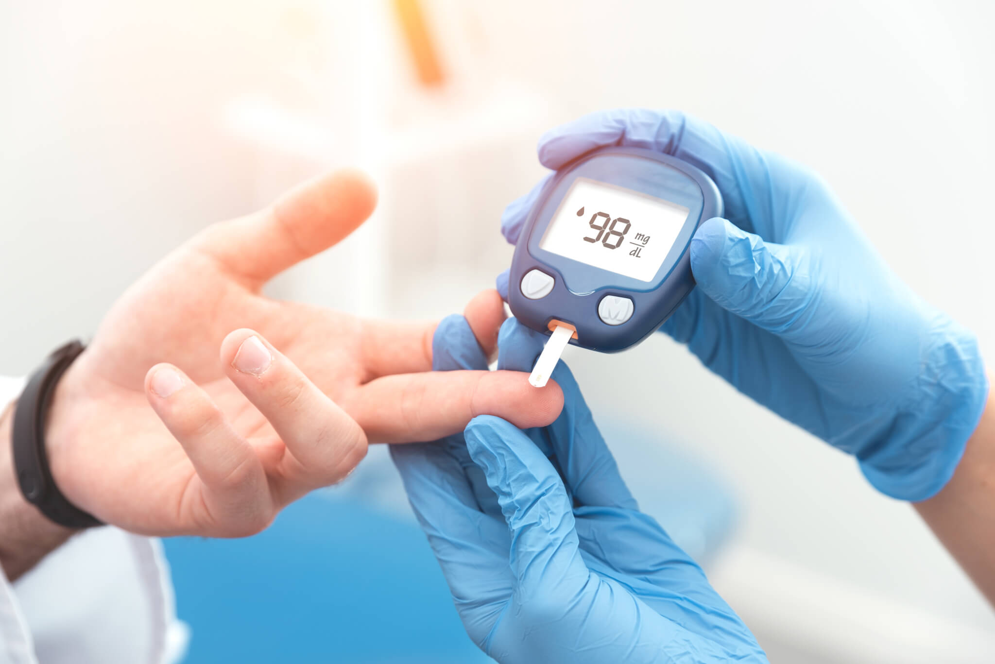 Doctor checking blood sugar level in diabetes patient