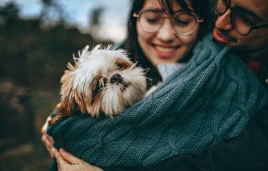 Couple hugging with a dog