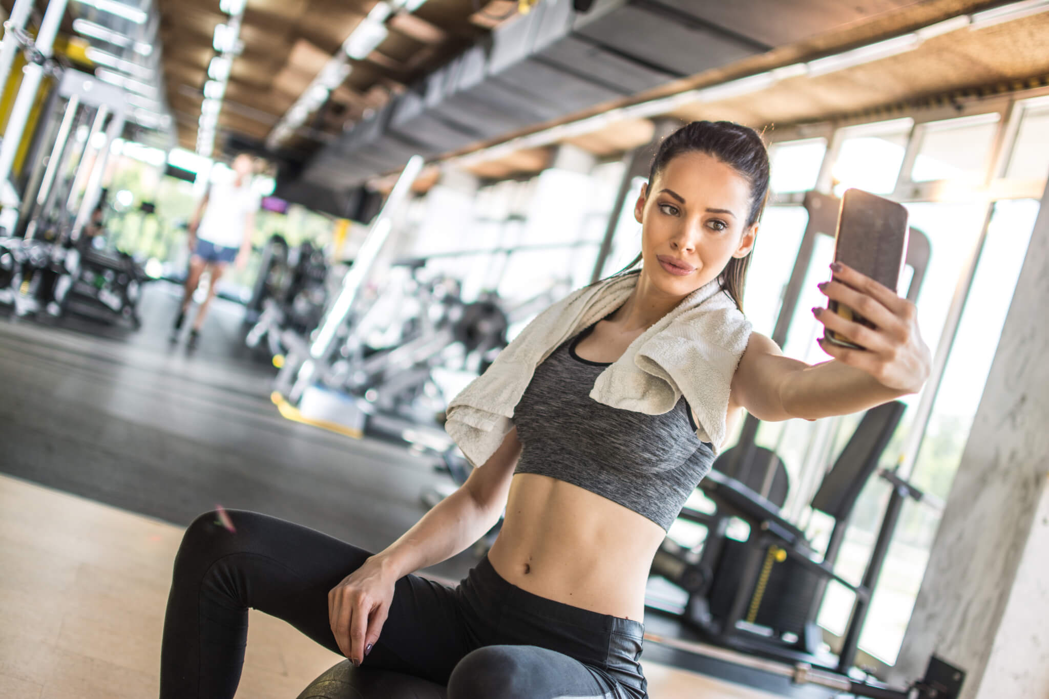 Woman taking selfie while exercising at the gym