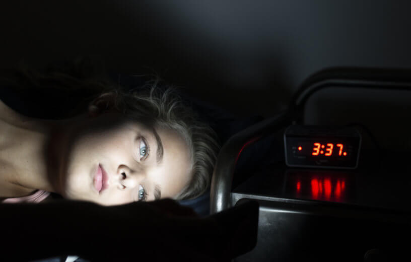 Teen or child awake in bed in middle of night