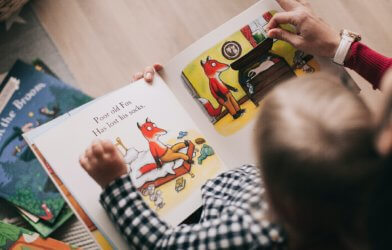 Parent reading book to child
