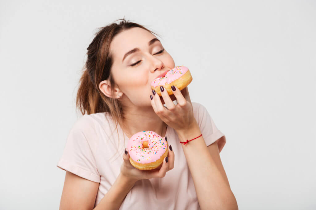 Woman eating doughnuts, junk food