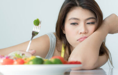 Woman doesn't want to eat vegetables or salad