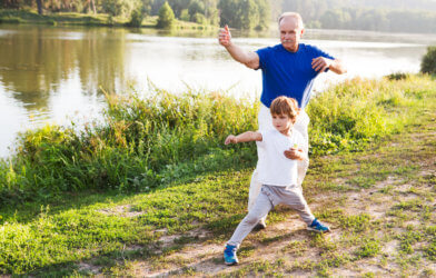 Boy practicing Tai Chi with grandfather