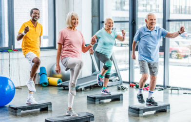 Seniors doing aerobic exercise class at gym