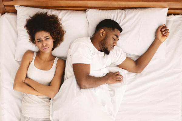 Couple in bed: Woman can't sleep, angry at man
