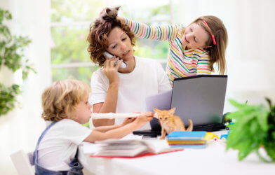 Mother doing work, stressed with children