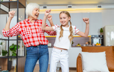 Grandmother and granddaughter dancing