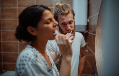 Couple brushing teeth together in the bathroom