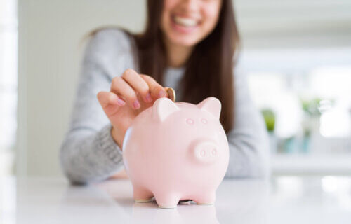 Woman saving money in piggy bank