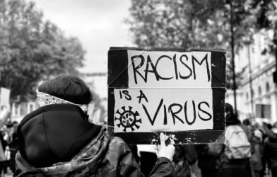 'Racism is a virus' sign at Black Lives Matter protest