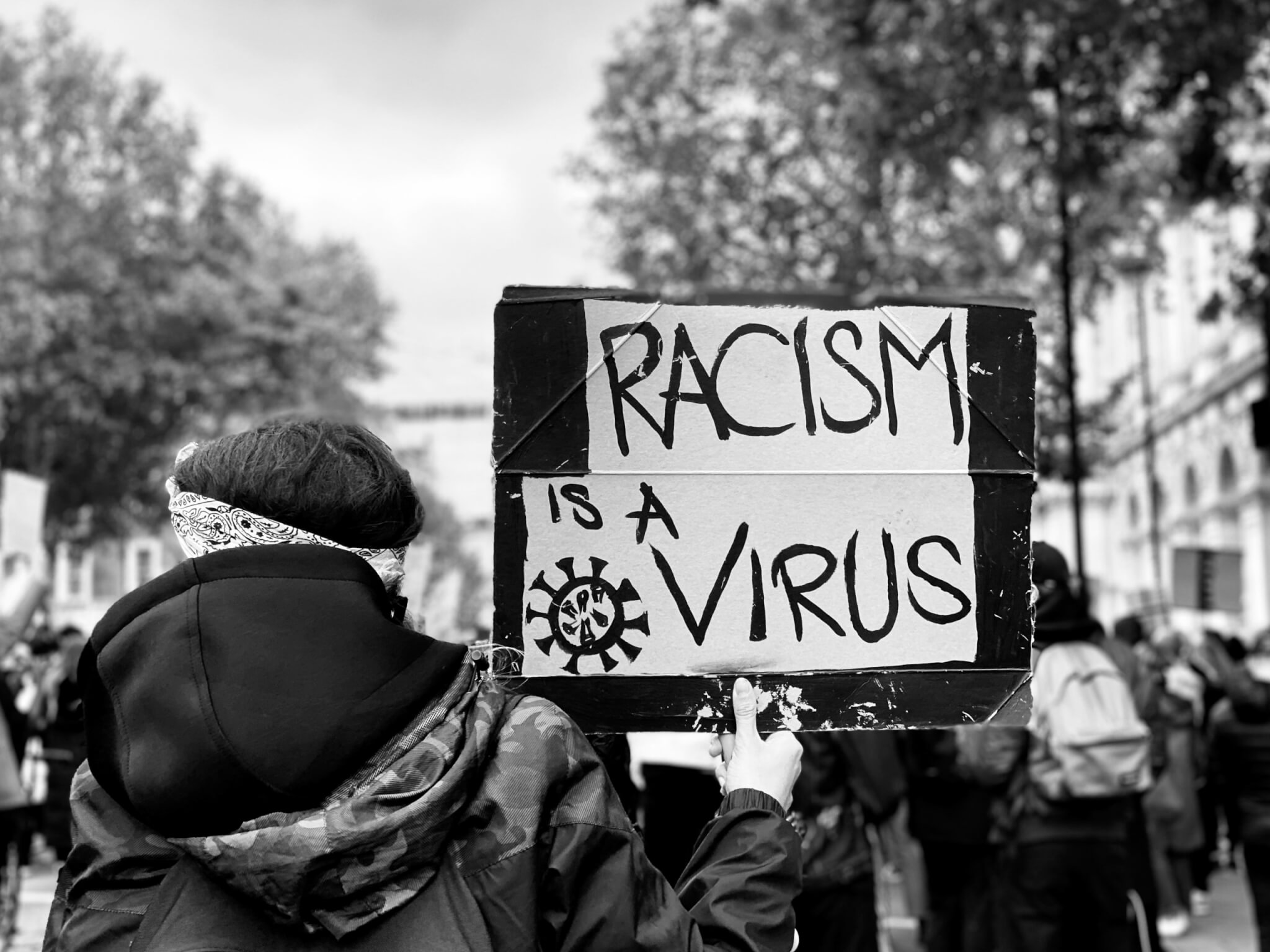 'Racism is a virus' sign at Black Lives Matter protest
