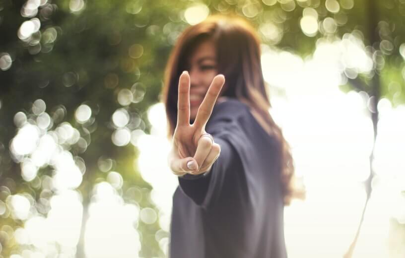 Woman showing 'peace' sign