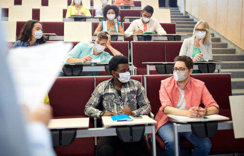 College students wearing masks during lecture for coronavirus / COVID-19 protections