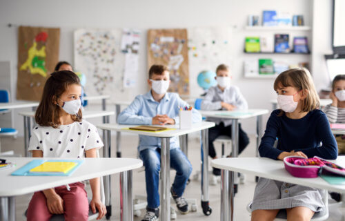 Children wearing masks in school during coronavirus / COVID-19 outbreak