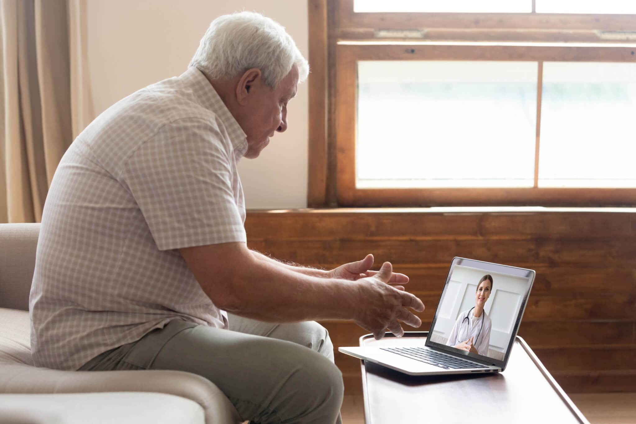 Telehealth for seniors: Older man on a virtual doctor's visit