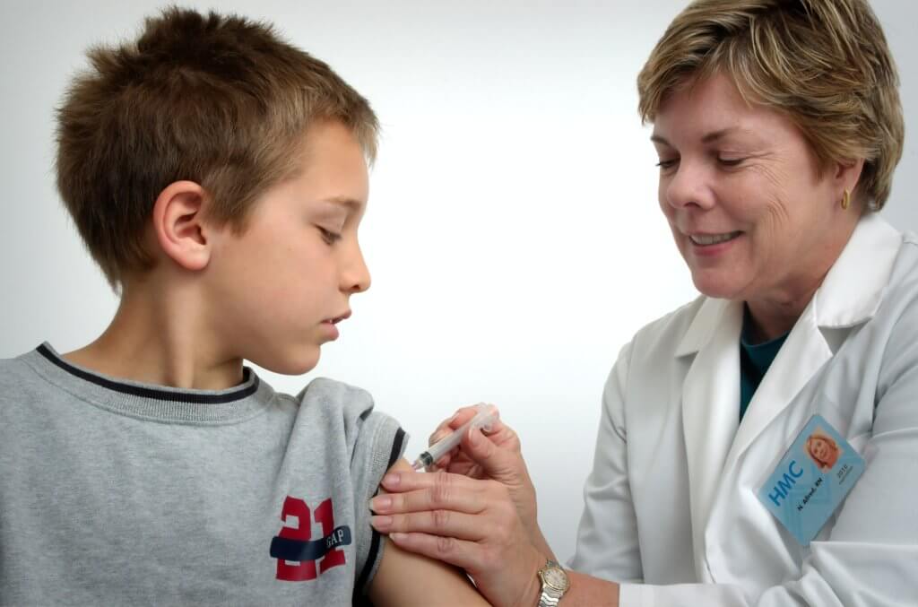 Child receiving vaccine at doctor's office