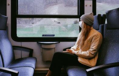 Woman on train wearing mask during coronavirus / covid-19 outbreak