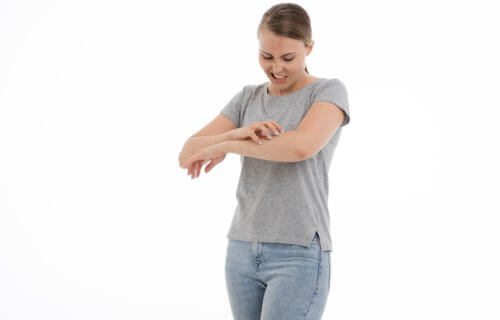 Woman scratching an itch on her arm