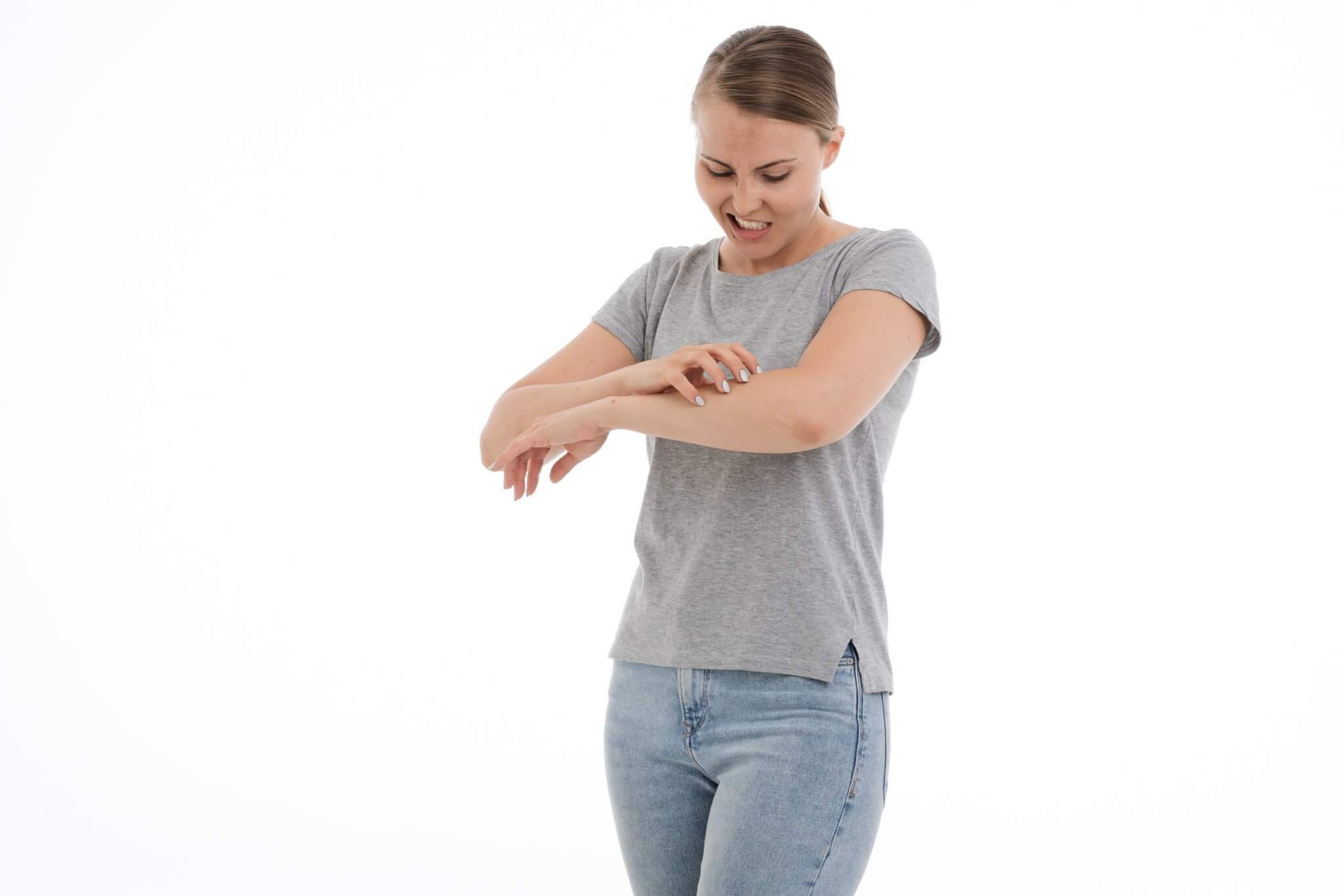 Woman scratching an itch on her arm