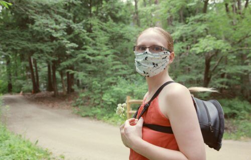 Woman wearing face mask during nature walk