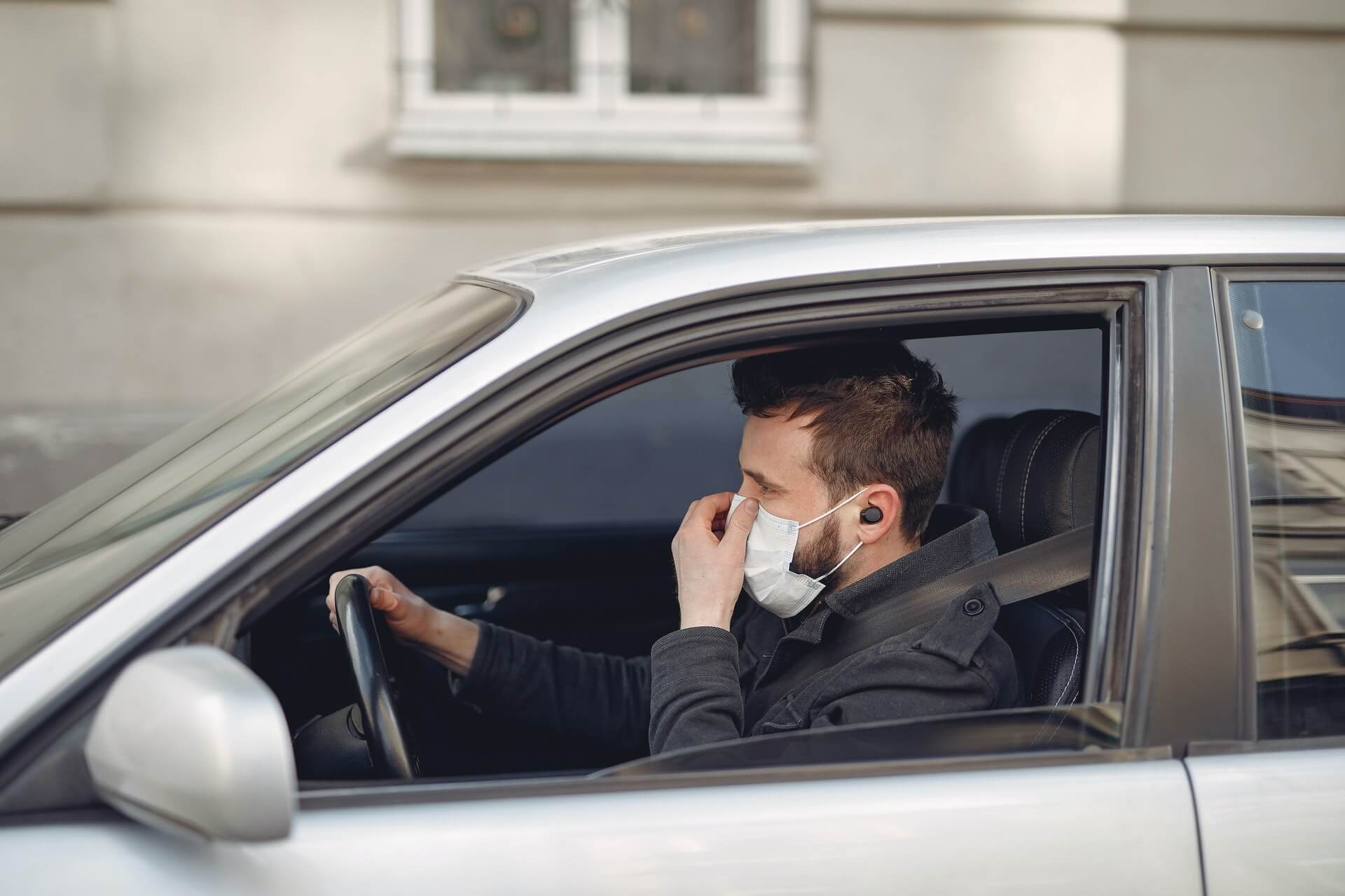 Man driving with face mask