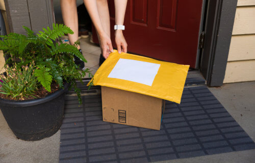 Person picking up packages from front door