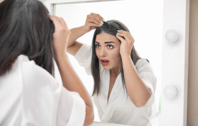 Woman finds gray hair looking in mirror