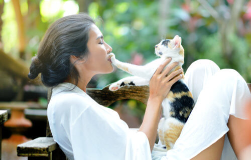 Woman playing with pet cat