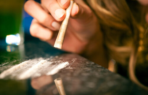 Woman snorting cocaine