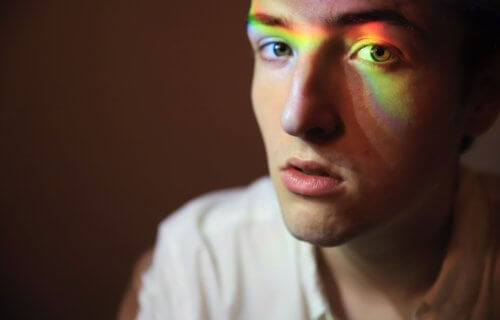 Gay man with rainbow over face for LGBTQ rights
