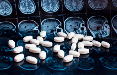 Medicine, pills on top of brain MRI scans