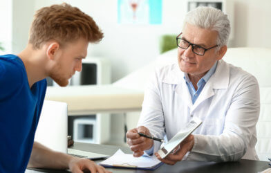 Doctor talking to male patient