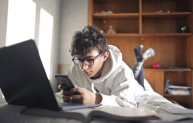 Screen time: Teen child using smartphone and computer