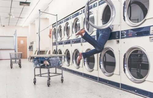 Person doing laundry at laundromat