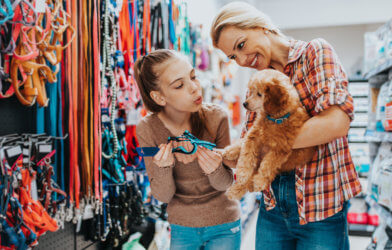 Mother, daughter with dog at pet store