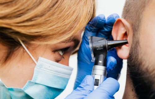 Doctor looking into human ear