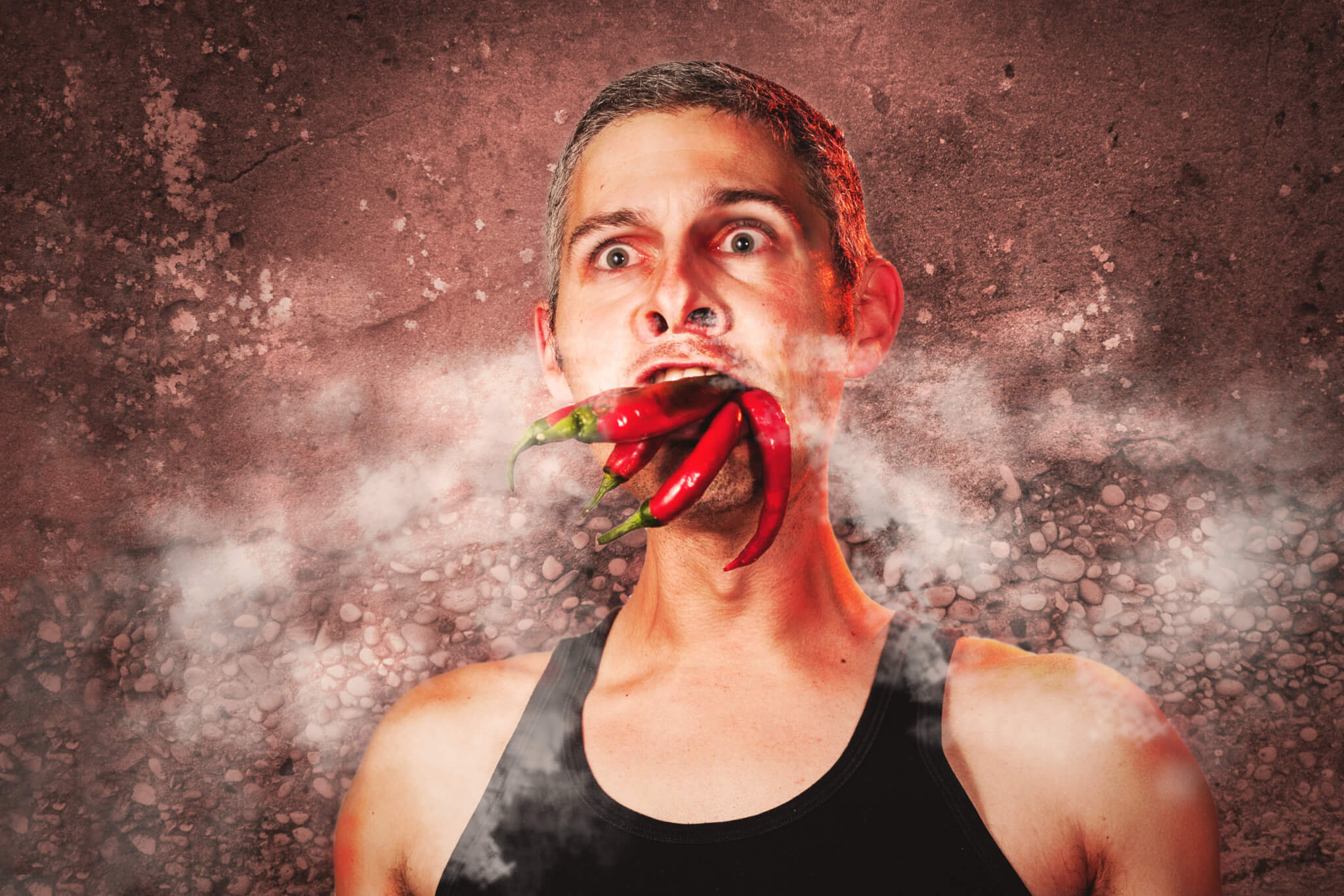 Man eating spicy hot peppers