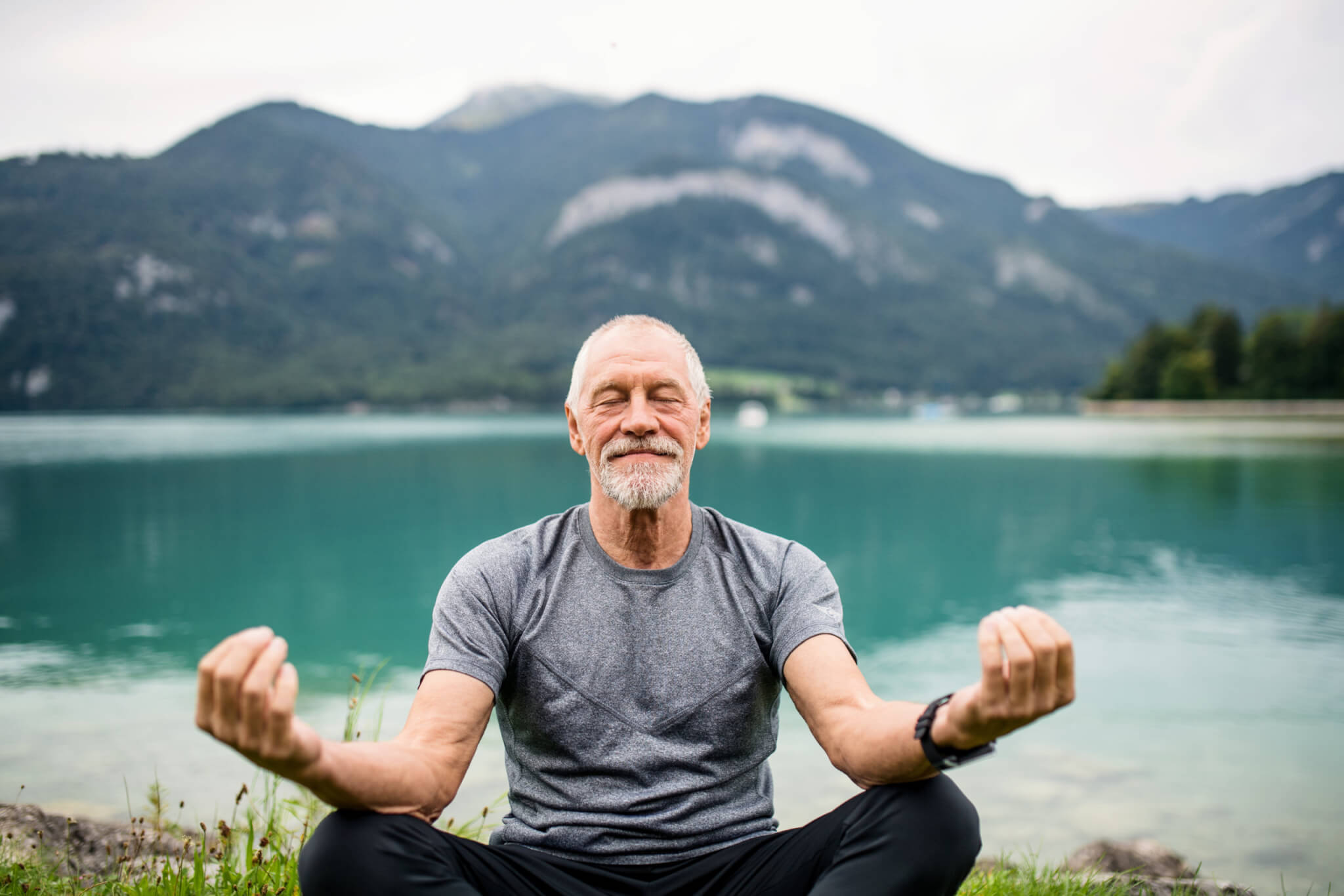 Senior, older man doing yoga or mindfulness meditation