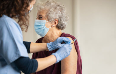 Older woman receiving COVID-19 vaccine