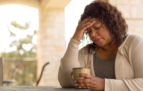 Middle-aged woman feeling sad or depressed, or having menopause symptoms