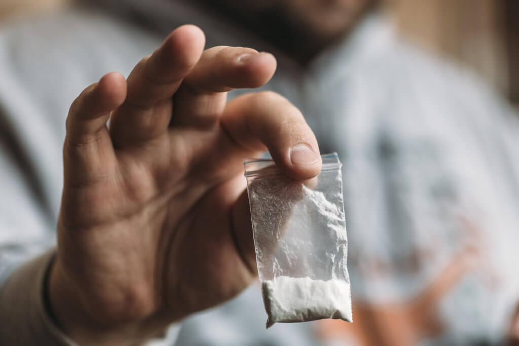 Man holding bag of cocaine