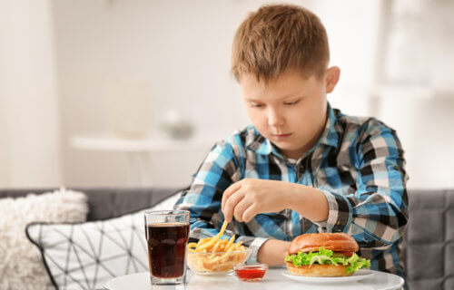 Child eating fast food at home