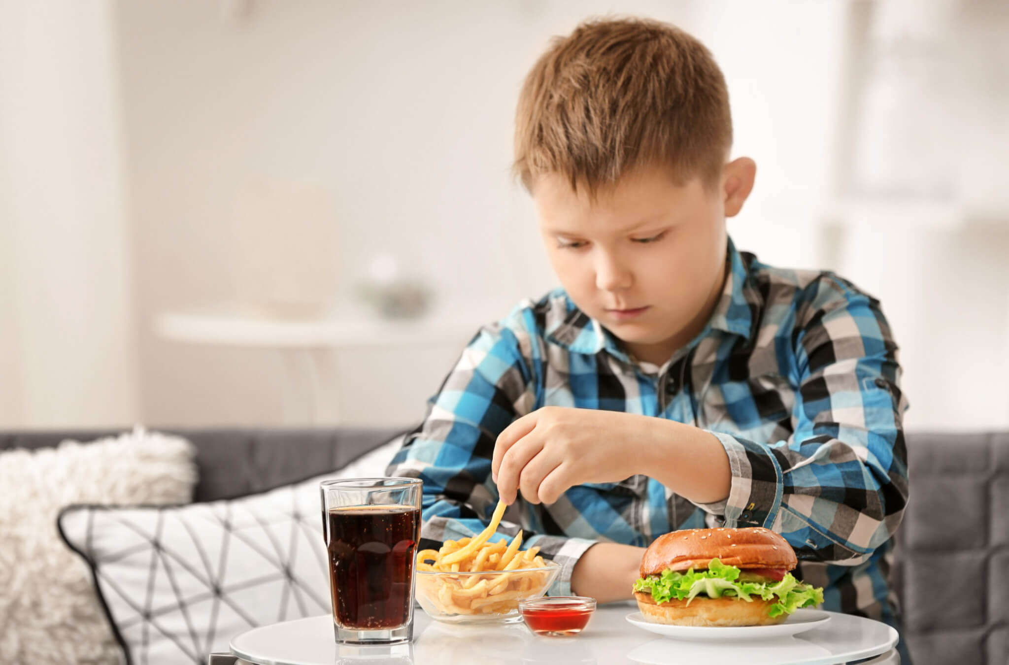 Child eating fast food at home