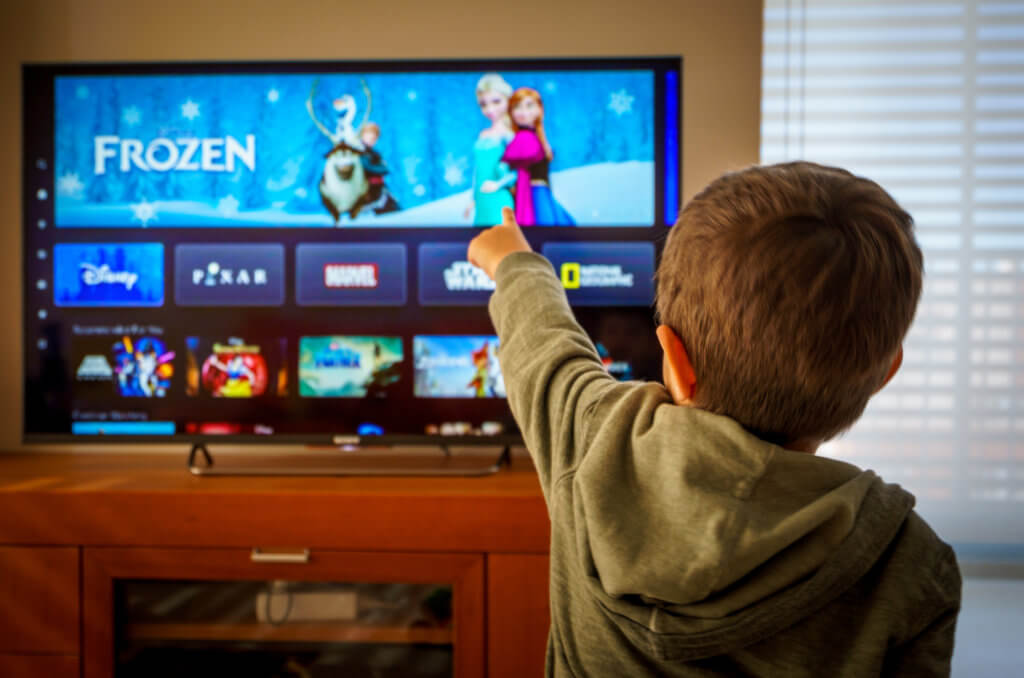 Boy watching Disney+ streaming on TV