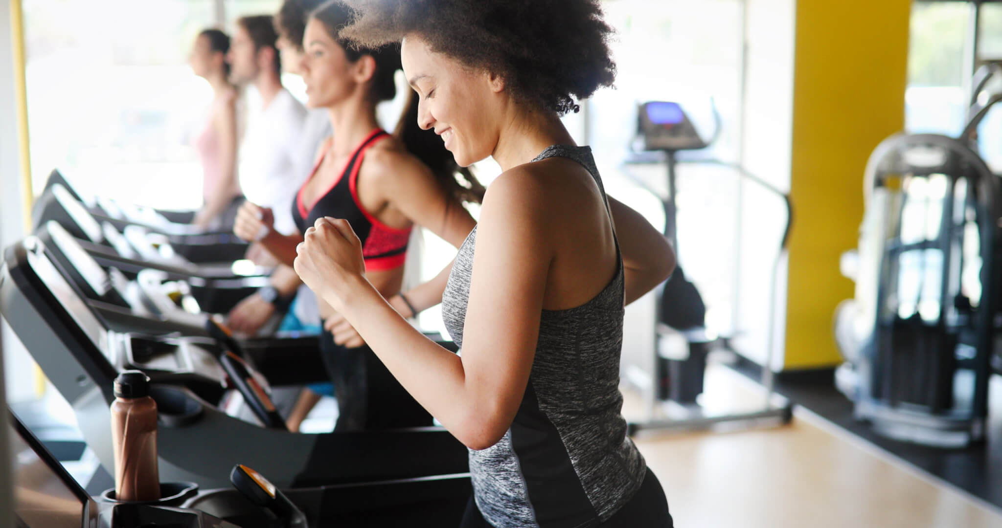 Women running on treadmill, working out