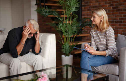 Older man talking to psychologist, therapist